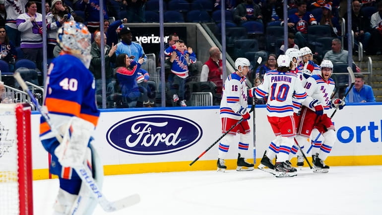Rangers' Andrew Copp (18) celebrates with teammates after scoring a...