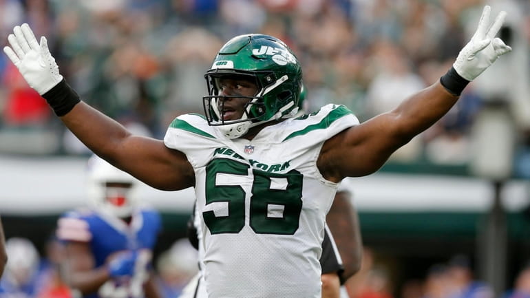 Carl Lawson of the New York Jets reacts against the Bills...