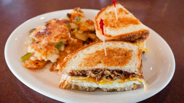 A pulled pork sandwich melt with egg, pepperjack cheese and...