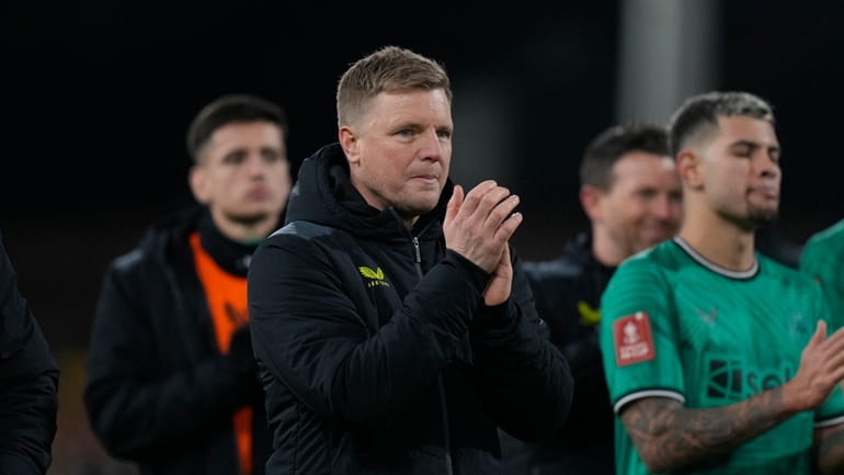 Newcastle's head coach Eddie Howe applauds fans at the end...