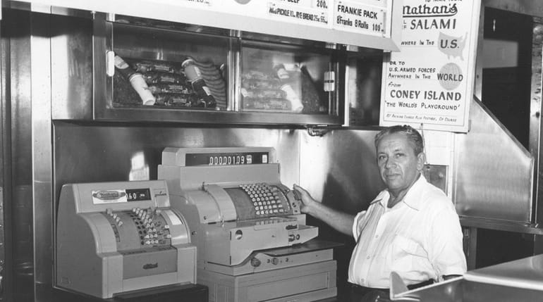 Nathan Handwerker behind the counter of his hot dog restaurant...