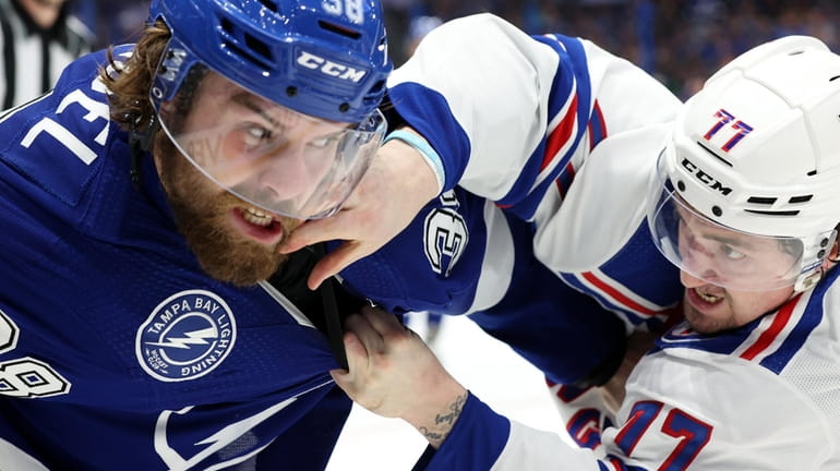 Brandon Hagel of the Tampa Bay Lightning fights with Frank...
