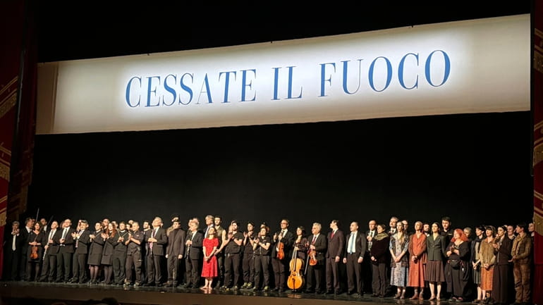 La Scala's dance company and the orchestra stand on stage...