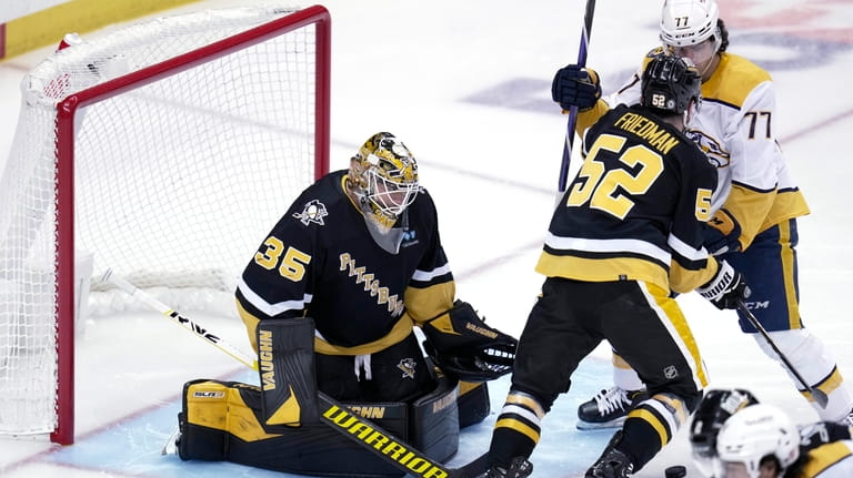 Pittsburgh Penguins goaltender Tristan Jarry (35) stops a shot as...