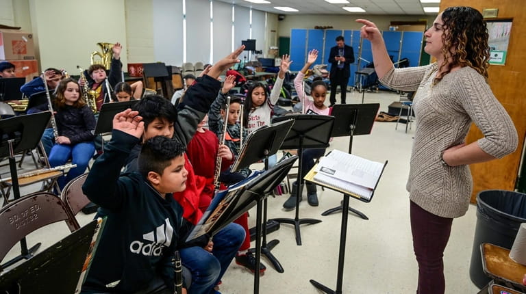 Sharon Kitzis leads the Nathaniel Woofhull fifth-grade band as they...