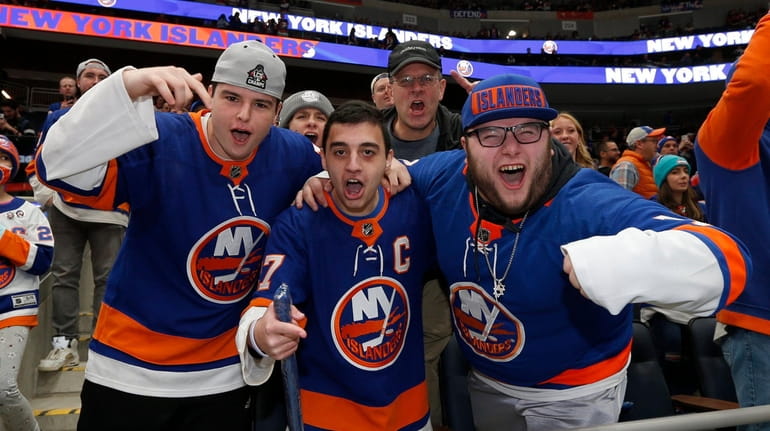 Fans cheer as the New York Islanders warm up before...