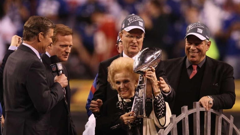 Giants co-owner Ann Mara poses with the Vince Lombardi trophy...