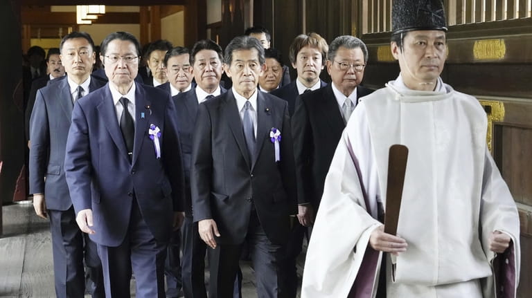 Japanese lawmakers visit the Yasukuni Shrine in Tokyo to offer...