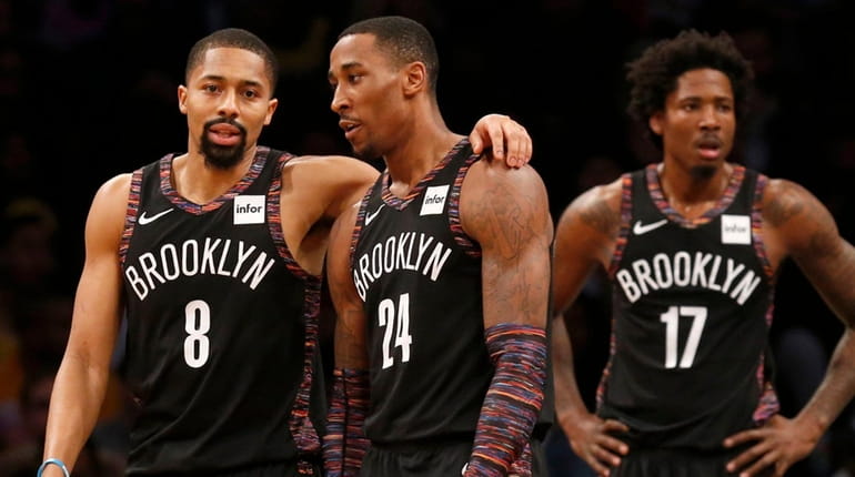 The Nets' Spencer Dinwiddie, Rondae Hollis-Jefferson and Ed Davis look on...