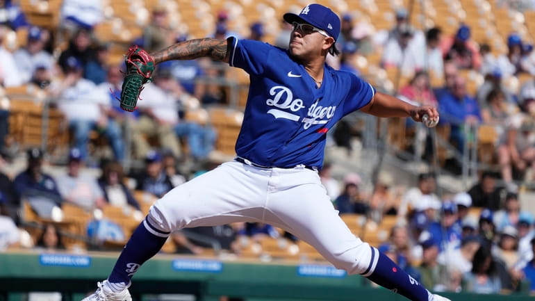 Los Angeles Dodgers starting pitcher Julio Urias throws a pitch...