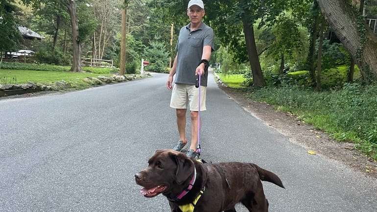 Expressway essay writer Matthew Hickerson takes his chocolate Lab, Lilah, for a...