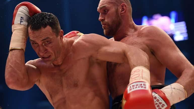 World heavyweight boxing champion Wladimir Klitschko, left, of Ukraine defending...
