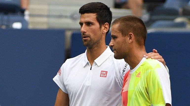Novak Djokovic of Serbia is seen with Mikhail Youzhny of...
