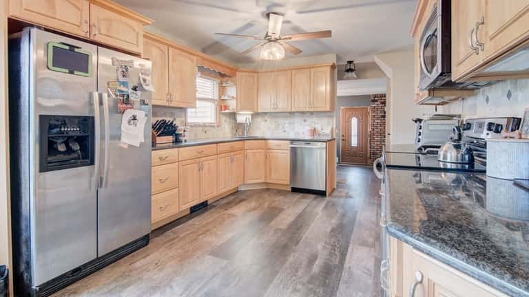 The kitchen has granite counters and stainless steel appliances.