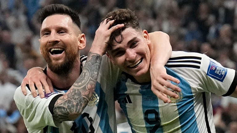 Argentina's Lionel Messi, left, and Argentina's Julian Alvarez celebrate after...