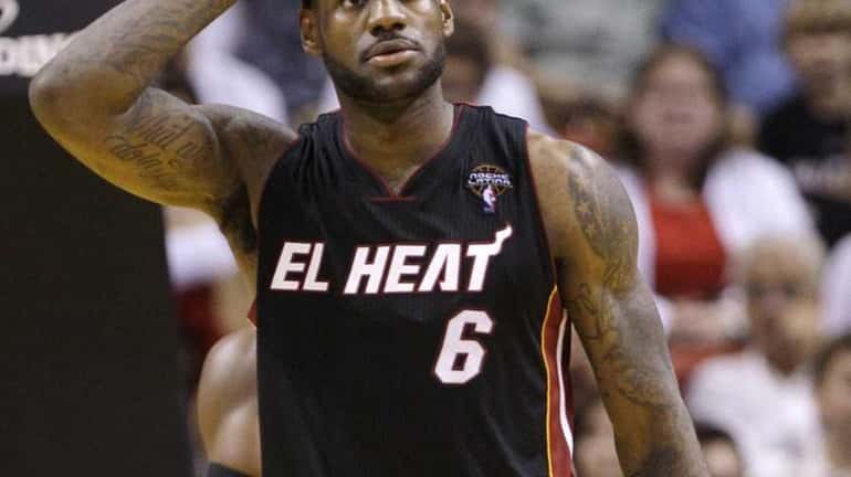 Miami Heat's LeBron James (6) reacts after fouling in the...