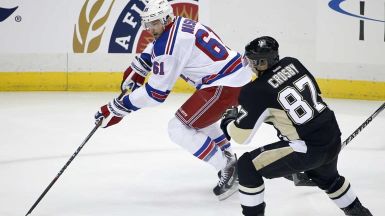 The New York Rangers' Rick Nash (61) skates past the...