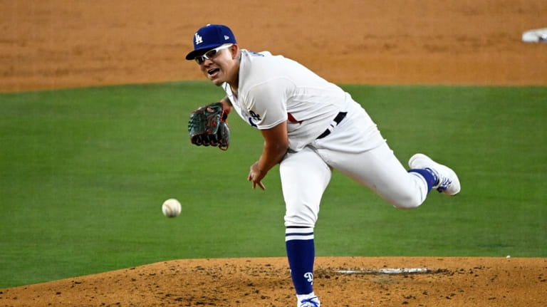 Los Angeles Dodgers starting pitcher Julio Urias throws to the...
