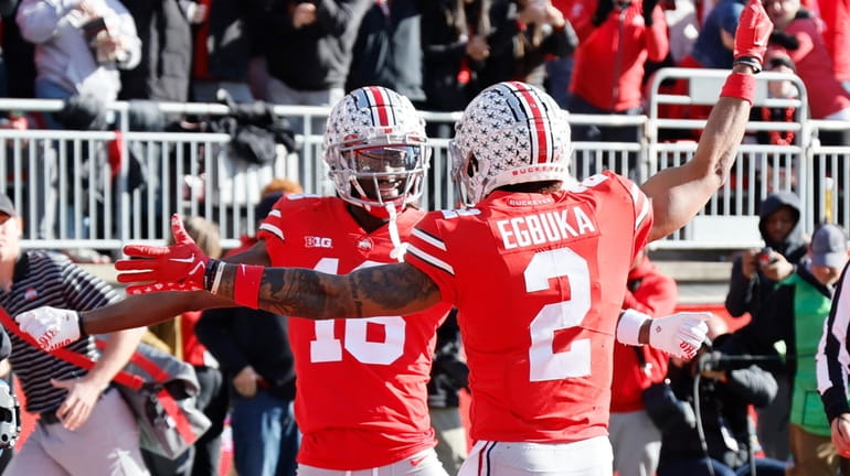 Ohio State receiver Marvin Harrison, left, celebrates his touchdown against...