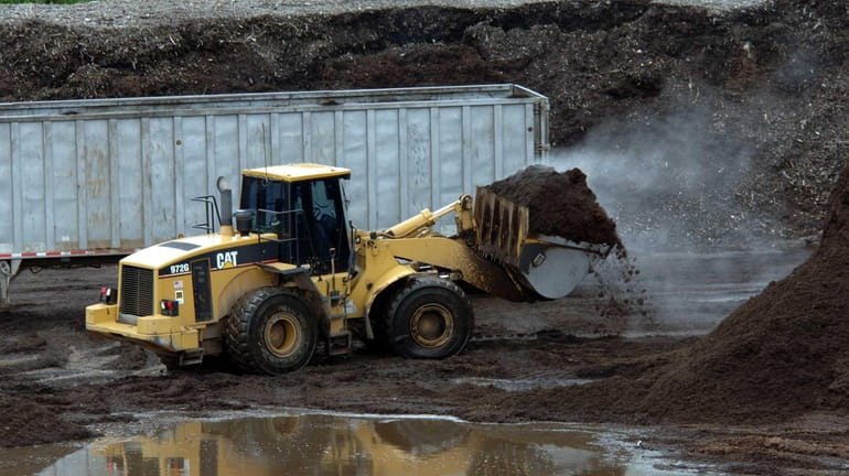 A bulldozer works at the site of one of Long...