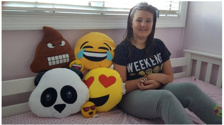 Kidsday reporter Amabelle Flannery with her emoji pillows.