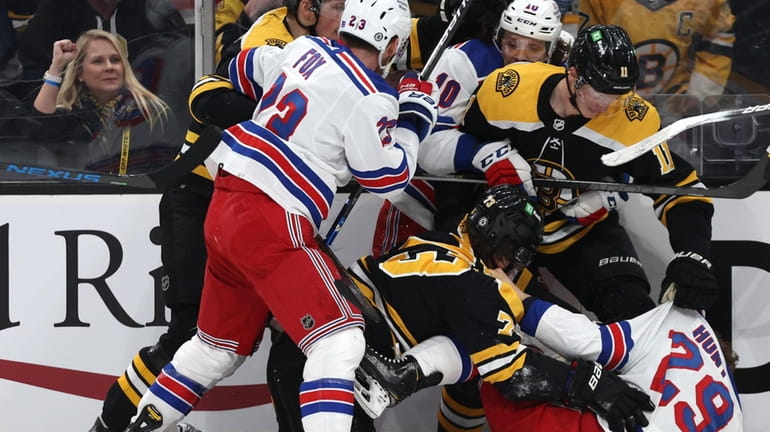 Dryden Hunt #29 of the Rangers and Charlie McAvoy #73 of...