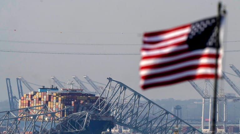 An American flag flies on a moored boat as the...