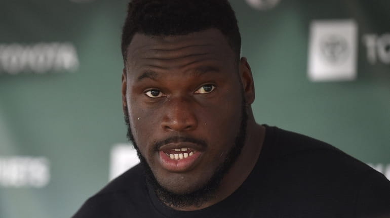Jets guard Kelechi Osemele speaks with the media after a day...