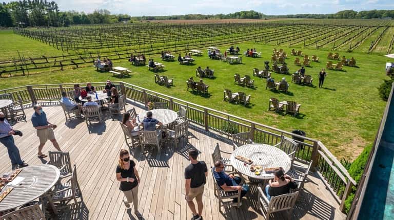 Visitors can overlooks the grounds at Paumanok Vineyards from socially...