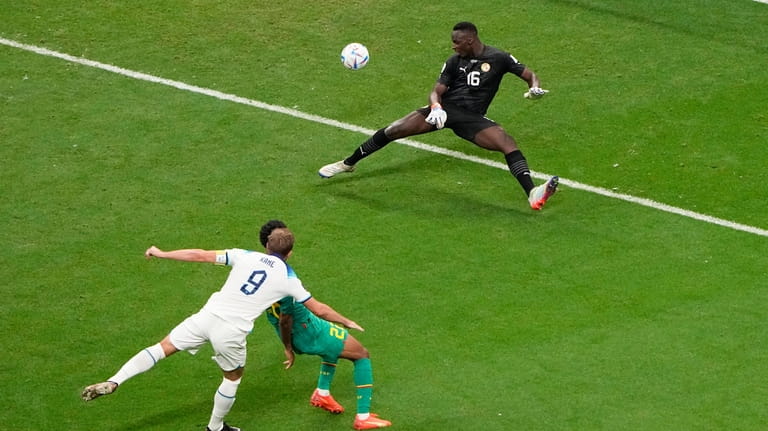 England's Harry Kane, left, scores his side's 2nd goal during...