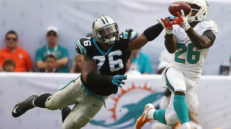 Miami Dolphins running back Lamar Miller grabs a pass as...