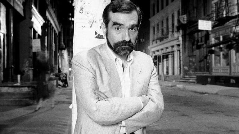 Portrait of American film director Martin Scorsese as he leans...