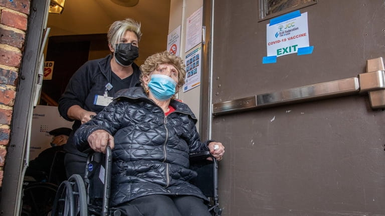 Holocaust survivor Bela Tekiel, 92, is wheeled out after getting...