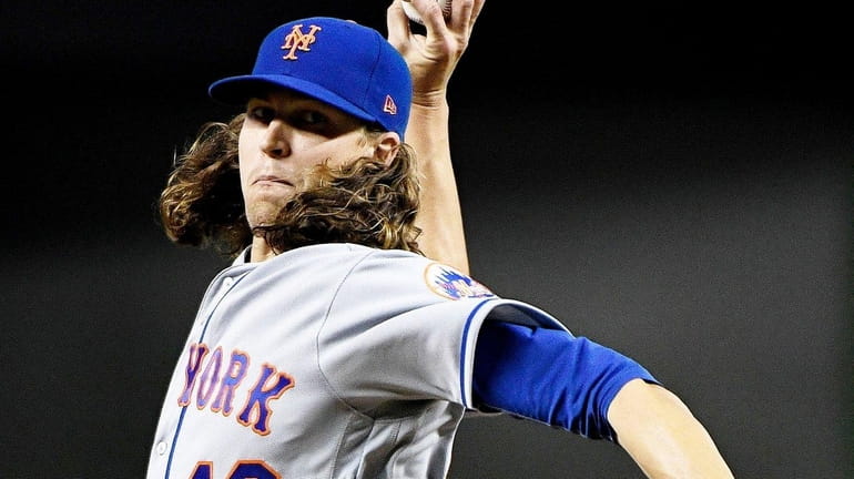 Jacob deGrom, #48, of the New York Mets pitches in...