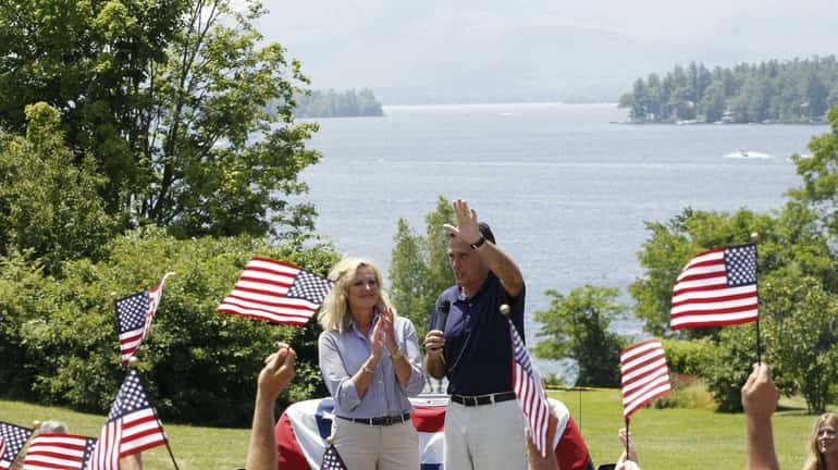 With Lake Winnipesaukee in the background, Republican presidential candidate Mitt...