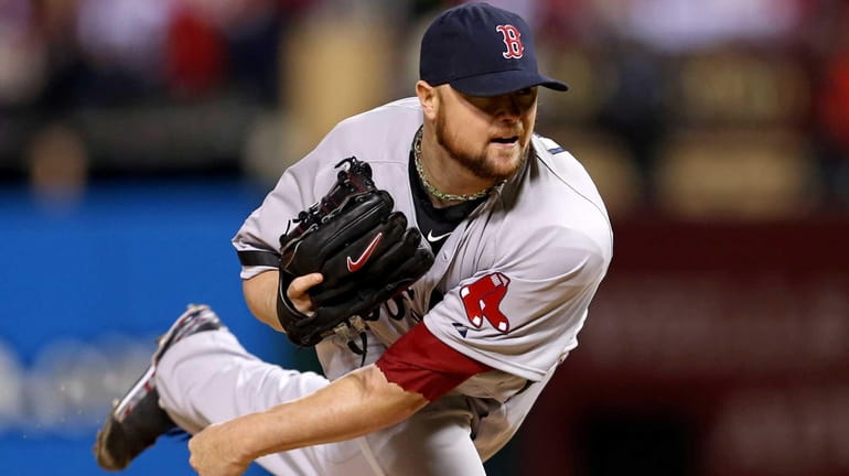 Boston Red Sox pitcher Jon Lester delivers a pitch during...