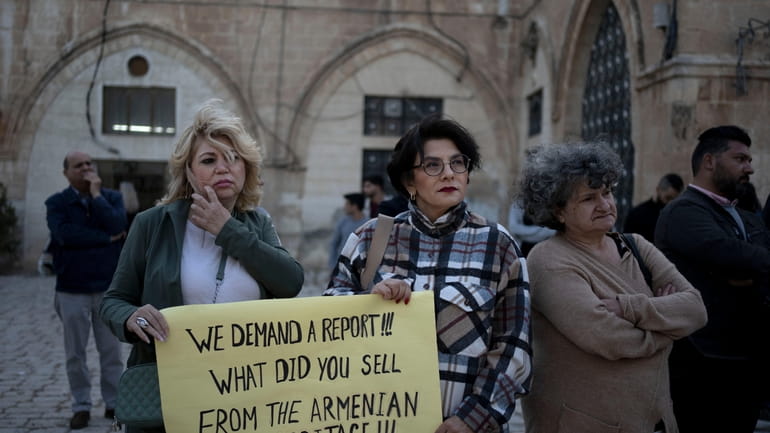 Members of the Armenian community protest a contentious deal that...