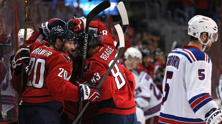 Troy Brouwer of the Washington Capitals and teammates surround Andre...