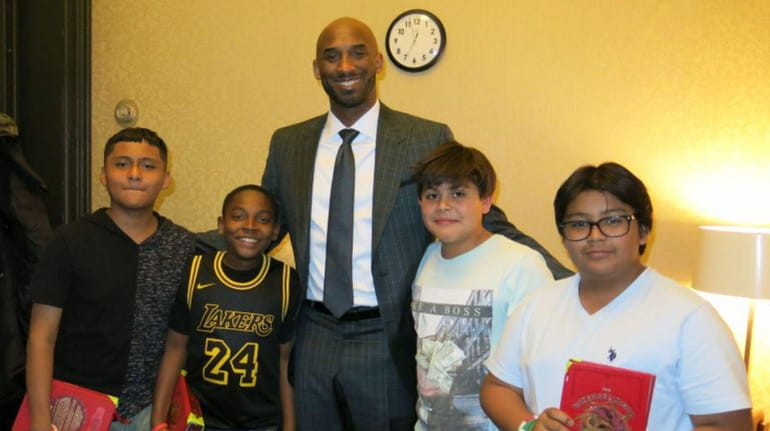 Retired NBA star Kobe Bryant with Kidsday reporters Humberto Guevara,...