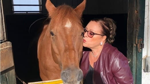 Gloria Schramm kisses Moon, her first love at the HorseAbility...