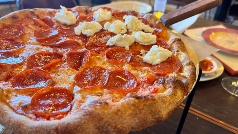 Honey pepperoni pizza topped with ricotta and homemade spicy honey...