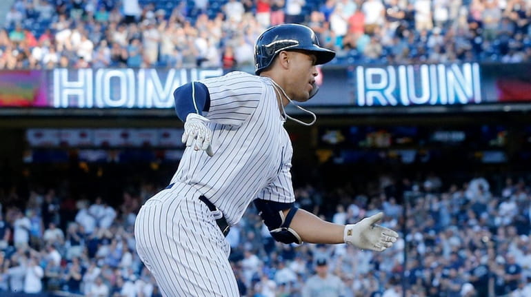 Giancarlo Stanton of the Yankees runs the bases after his...