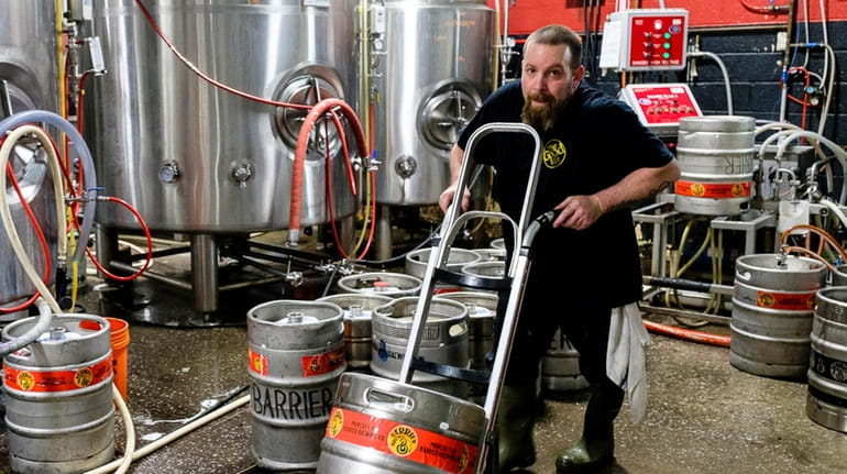 A worker inside Barrier Brewing Co. in Oceanside, which picked up a...