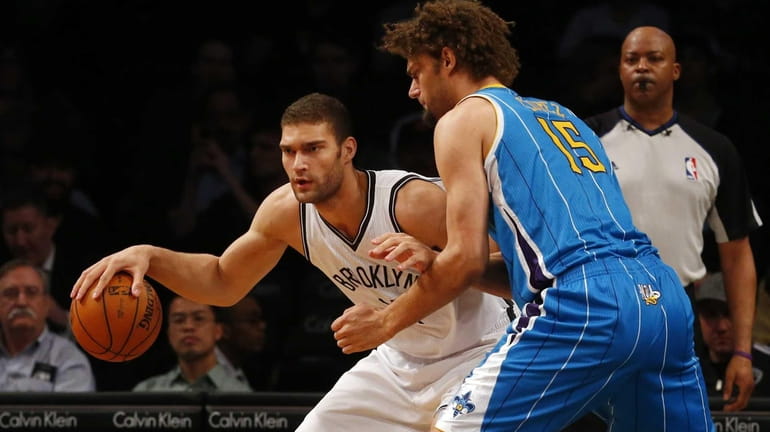 Brook Lopez of the Brooklyn Nets controls the ball against...