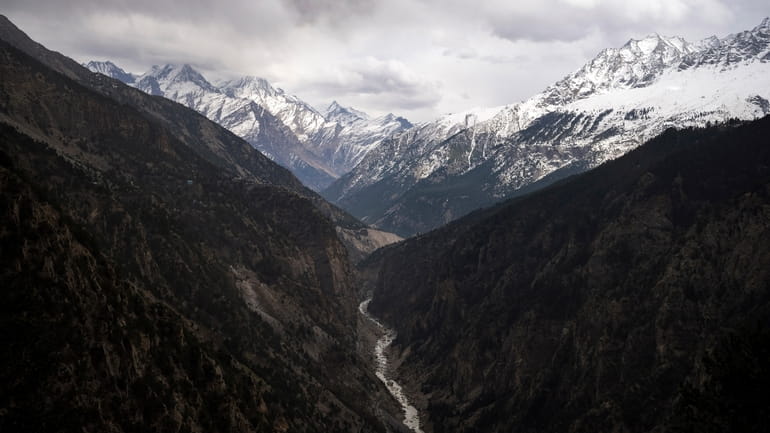 The Sutlej River flows in the valley below the tall...