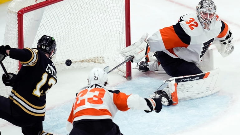 Boston Bruins' Charlie Coyle (13) scores on Philadelphia Flyers' Felix...