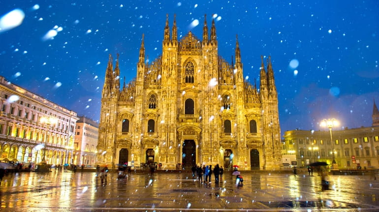 Milan's Duomo Cathedral is bathed in artificial lights on a...