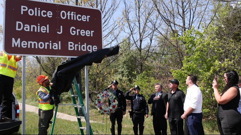 Greer's family and police officers at the ceremony Friday.