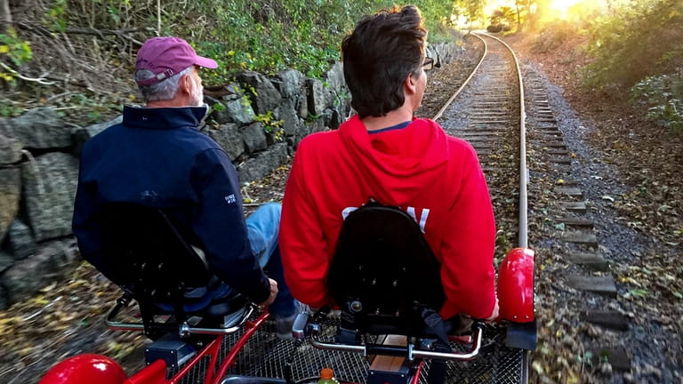 A pair pedals a Rail Explorers railbike while traveling the...