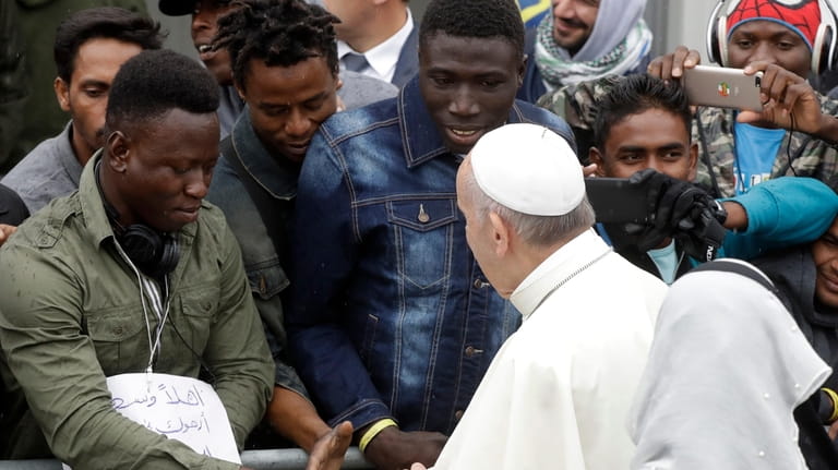 Pope Francis arrives at a regional migrant center to meet...